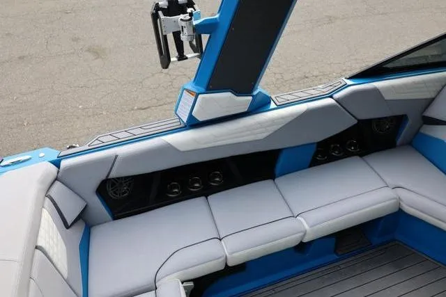 Slide: The Image of Interior seating of 2022 Nautique Super Air Nautique S23 boat, featuring blue and gray upholstery. - 47