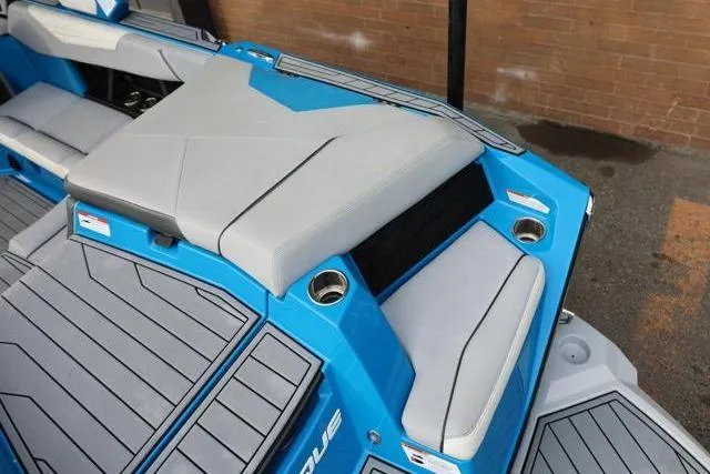 Slide: The Image of 2022 Nautique Super Air Nautique S23 boat interior with blue and gray seating. - 48