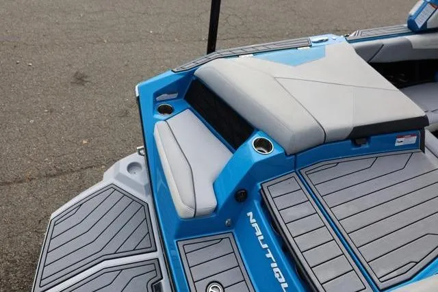 Slide: The Image of 2022 Nautique Super Air Nautique S23 boat interior with blue and gray seating. - 51