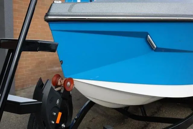 Slide: The Image of 2022 Nautique Super Air Nautique S23 boat on trailer, blue hull detail. - 53