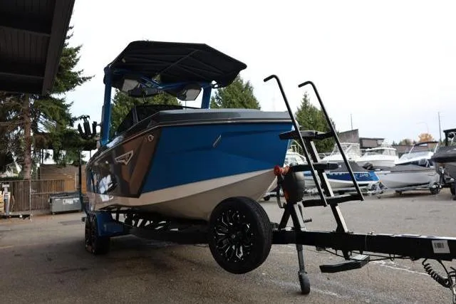 Slide: The Image of 2022 Nautique Super Air Nautique S23 boat on trailer, parked outdoors. - 54