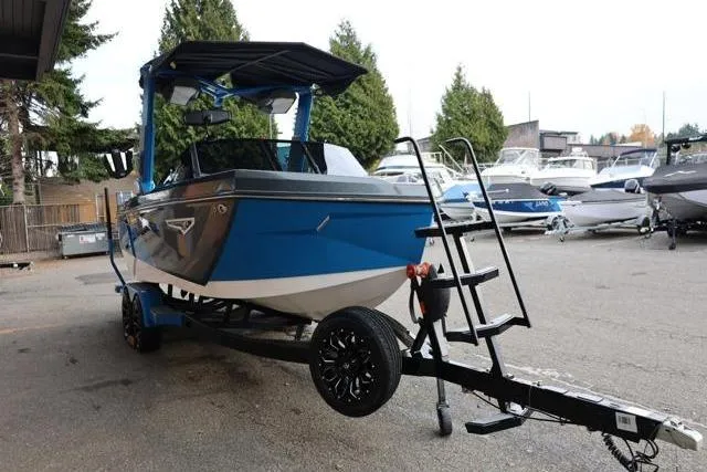 Slide: The Image of 2022 Nautique Super Air Nautique S23 boat on trailer, parked outdoors. - 57