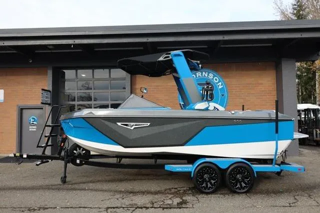 Slide: The Image of 2022 Nautique Super Air Nautique S23 boat in blue and gray on a trailer. - 6
