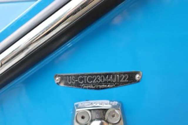 Slide: The Image of 2022 Nautique Super Air Nautique S23 boat identification plate on blue surface. - 61