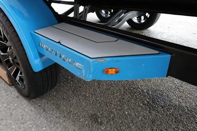 Slide: The Image of 2022 Nautique Super Air Nautique S23 trailer step, blue with logo and light. - 7