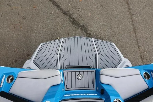 Slide: The Image of 2022 Nautique Super Air Nautique S23 boat deck, featuring blue and gray design. - 9