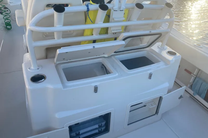 Slide: The Image of 2025 Grady-White Canyon 306 boat docked, featuring Garmin electronics and spacious deck. - 11