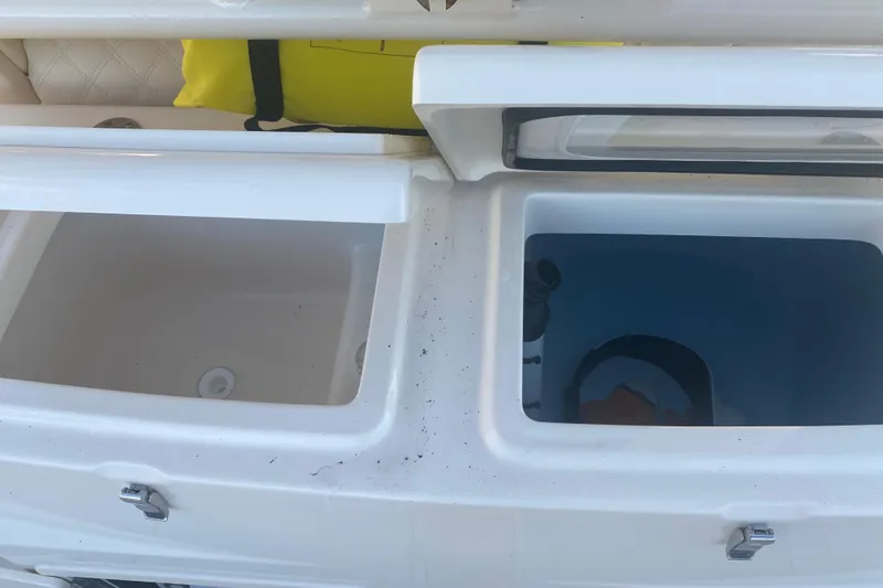 Slide: The Image of 2025 Grady-White Canyon 306 boat interior with storage compartments and rod holders. - 12