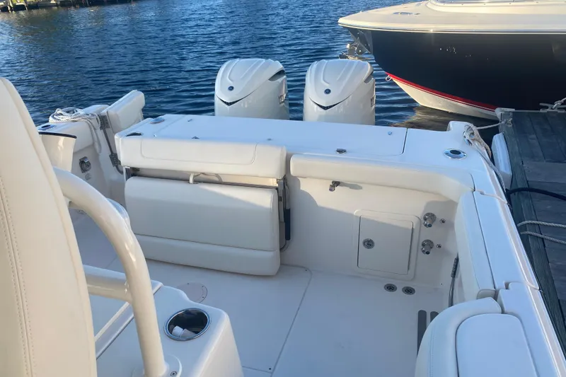 Slide: The Image of 2025 Grady-White Canyon 306 boat stern view with motor and rope on water. - 15