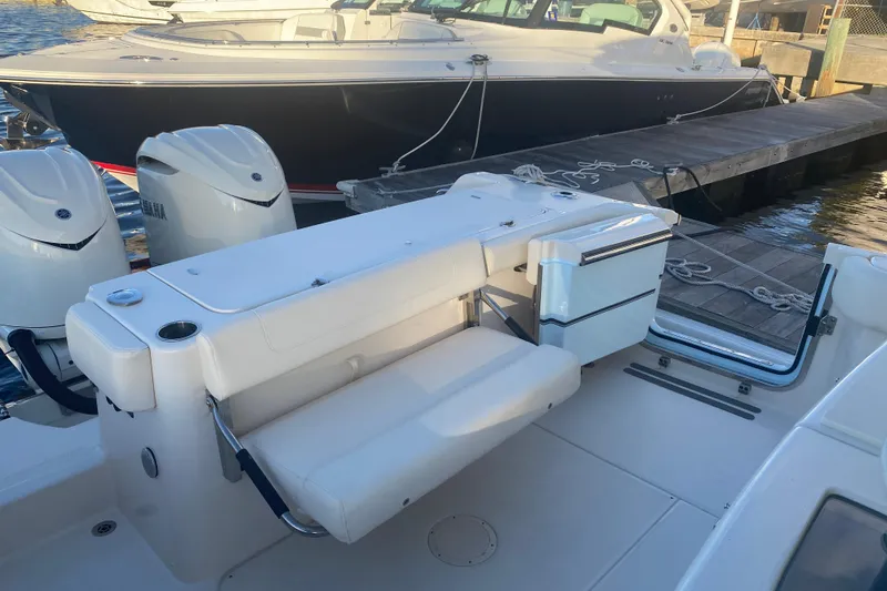 Slide: The Image of 2025 Grady-White Canyon 306 boat interior with triple outboard engines at dock. - 16