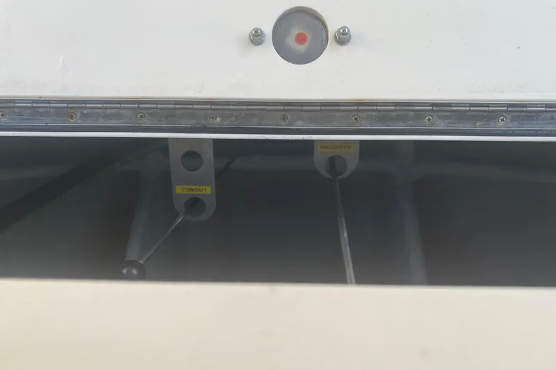 Slide: The Image of 2025 Grady-White Canyon 306 boat storage compartment with open lid and bucket inside. - 18