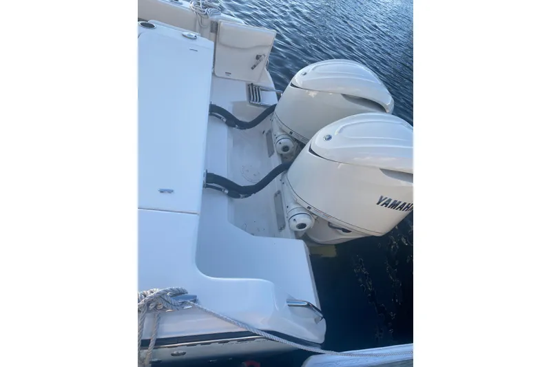 Slide: The Image of 2025 Grady-White Canyon 306 boat compartment with livewell and macerator controls. - 19