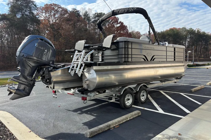 Slide: The Image of 2026 Veranda 22 FRC Plus 2 pontoon boat on trailer in parking lot. - 3