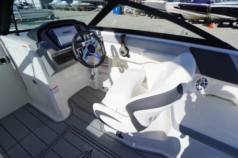 Slide: The Image of Interior of 2026 Chaparral 23 SSi OB boat with steering wheel and seating. - 32