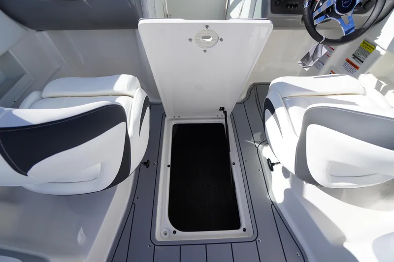 Slide: The Image of 2026 Chaparral 23 SSi OB boat interior with open storage compartment and seating. - 39