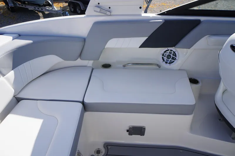 Slide: The Image of 2026 Chaparral 23 SSi OB boat interior with cushioned seating and speaker system. - 44