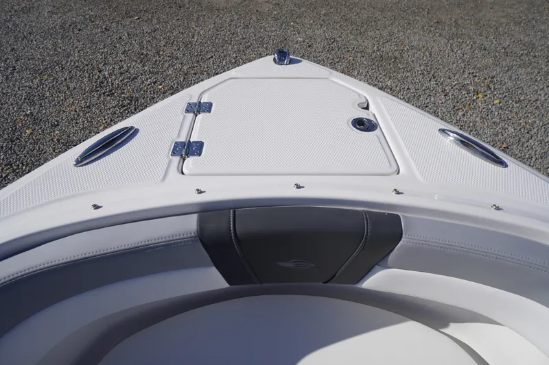 Slide: The Image of Bow of 2026 Chaparral 23 SSi OB boat with storage compartment and sleek design. - 5