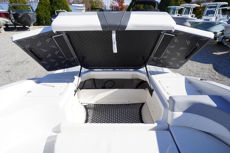 Slide: The Image of 2026 Chaparral 23 SSi OB boat storage compartment with open hatch, showcasing spacious interior. - 54