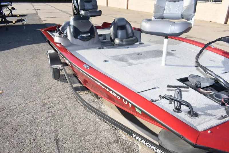 Slide: The Image of 2019 Tracker Pro Team 195 TXW Tournament Edition fishing boat, red exterior, parked on pavement. - 20