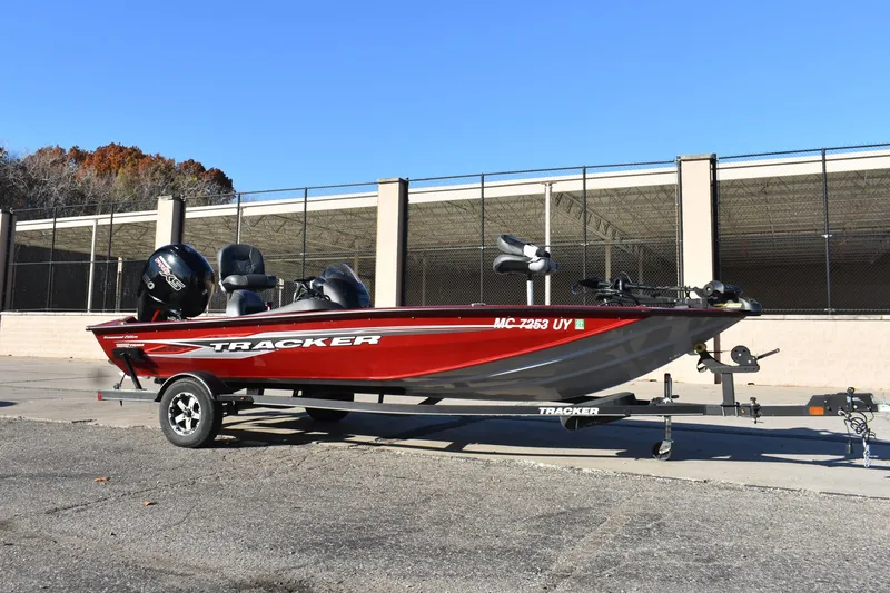 Slide: The Image of 2019 Tracker Pro Team 195 TXW Tournament Edition boat on trailer, parked outdoors. - 6