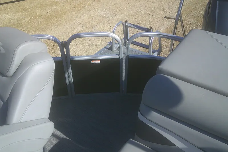 Slide: The Image of 2021 Bennington S 20 L-Bench pontoon boat interior with gray seating and railing. - 10