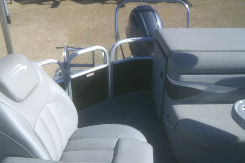 Slide: The Image of 2021 Bennington S 20 L-Bench boat interior with gray seating and motor view. - 11
