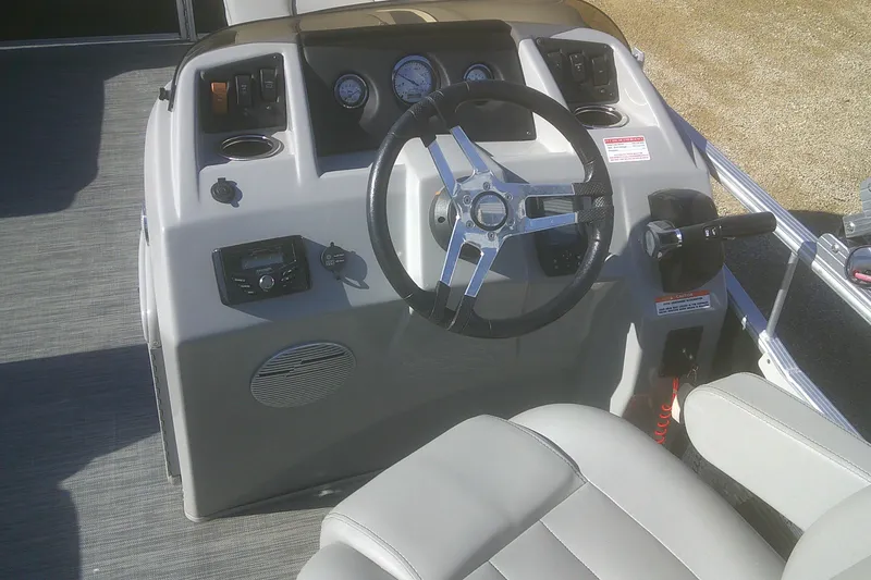 Slide: The Image of 2021 Bennington S 20 L-Bench boat dashboard with steering wheel and controls. - 12