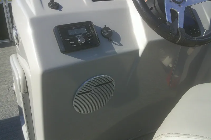 Slide: The Image of 2021 Bennington S 20 L-Bench boat dashboard with steering wheel and audio controls. - 13
