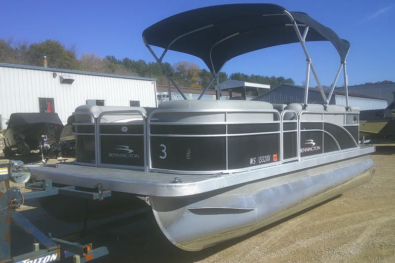 Slide: The Image of 2021 Bennington S 20 L-Bench pontoon boat with canopy in a storage yard. - 4