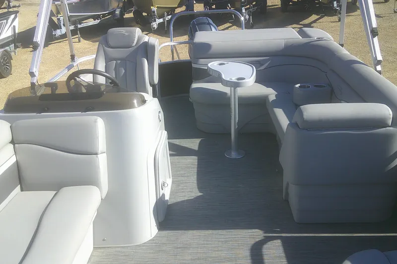 Slide: The Image of 2021 Bennington S 20 L-Bench pontoon boat interior with gray seating and helm. - 5