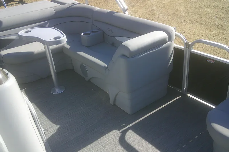Slide: The Image of 2021 Bennington S 20 L-Bench pontoon boat interior with gray seating and table. - 6