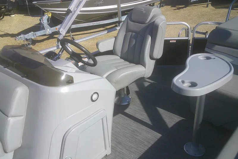 Slide: The Image of 2021 Bennington S 20 L-Bench boat interior with steering wheel and seating area. - 7