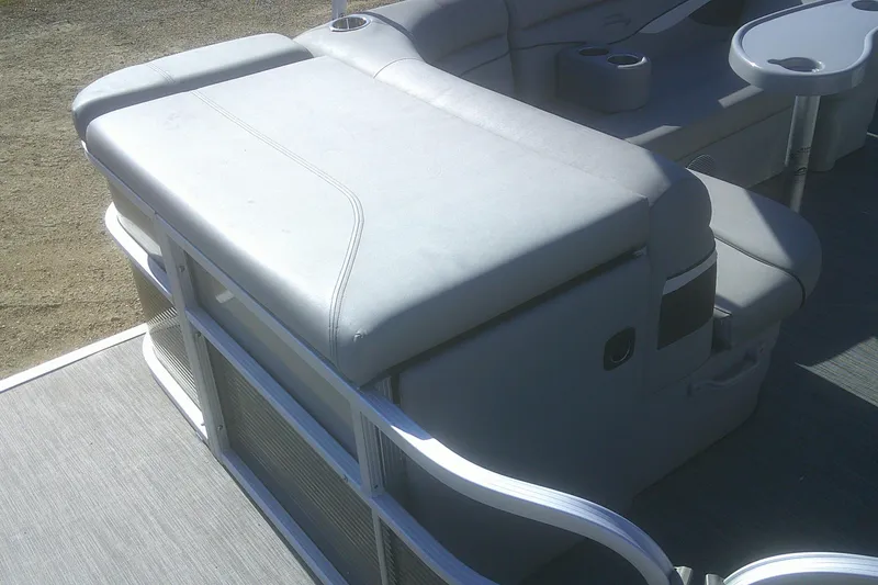 Slide: The Image of 2021 Bennington S 20 L-Bench pontoon boat with gray seating and cup holders. - 9