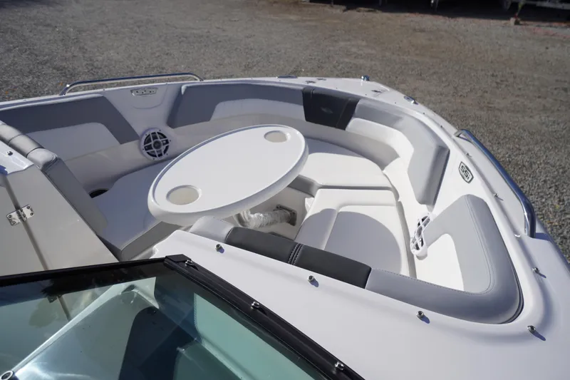 Slide: The Image of 2026 Chaparral 23 SSi OB boat interior with seating and table, showcasing luxury design. - 10