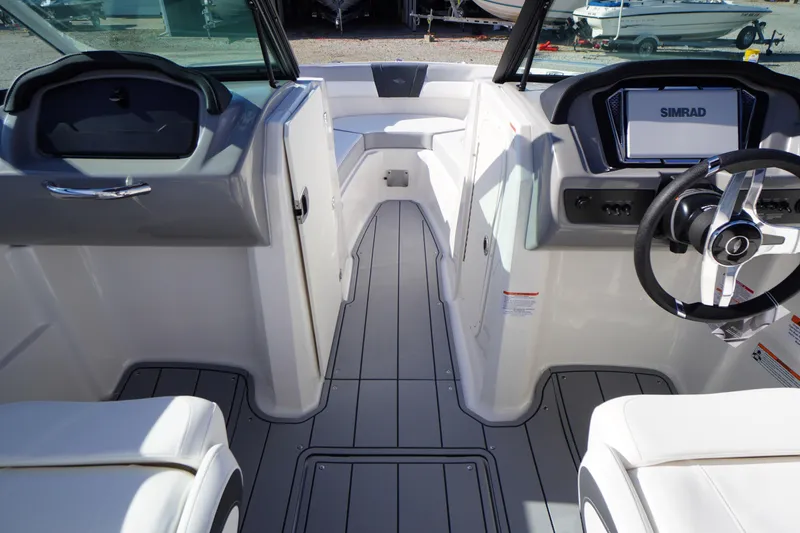 Slide: The Image of Interior view of 2026 Chaparral 23 SSi OB boat, featuring modern dashboard and seating. - 20