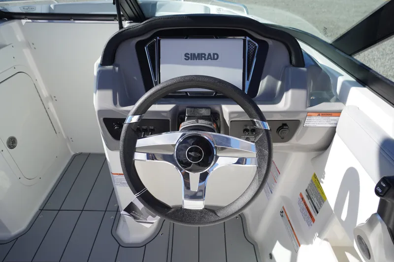 Slide: The Image of Steering console of 2026 Chaparral 23 SSi OB boat with Simrad display. - 23