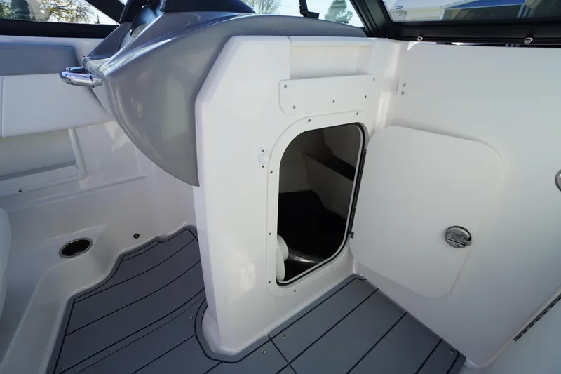 Slide: The Image of 2026 Chaparral 23 SSi OB boat interior with open storage compartment. - 29