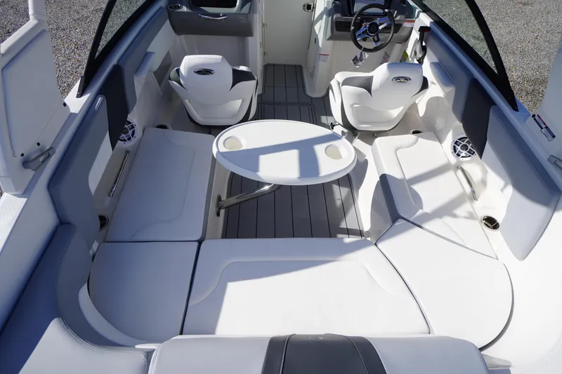 Slide: The Image of 2026 Chaparral 23 SSi OB boat interior with seating and table, showcasing modern design. - 46