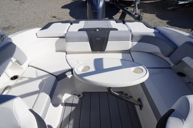 Slide: The Image of 2026 Chaparral 23 SSi OB boat interior with seating and table, showcasing luxury design. - 47