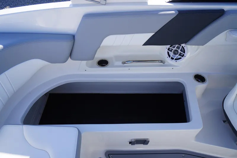 Slide: The Image of 2026 Chaparral 23 SSi OB boat interior with storage compartment and speaker. - 51