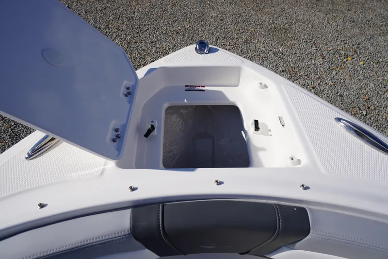 Slide: The Image of Open storage compartment on 2026 Chaparral 23 SSi OB boat, showing interior details. - 6