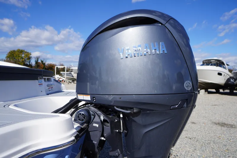 Slide: The Image of 2026 Chaparral 23 SSi OB with Yamaha outboard motor, parked outdoors. - 65