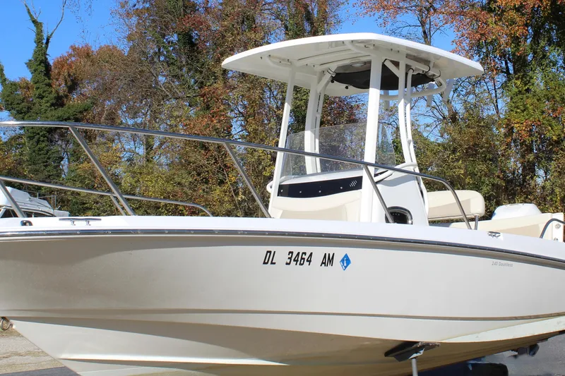 The Image of 2020 Boston Whaler 240 Dauntless boat with T-top, parked outdoors in autumn setting. - 0