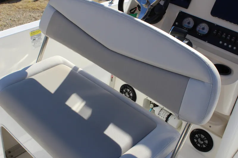 Slide: The Image of Boston Whaler 240 Dauntless 2020 boat interior with cushioned seating and control panel. - 10