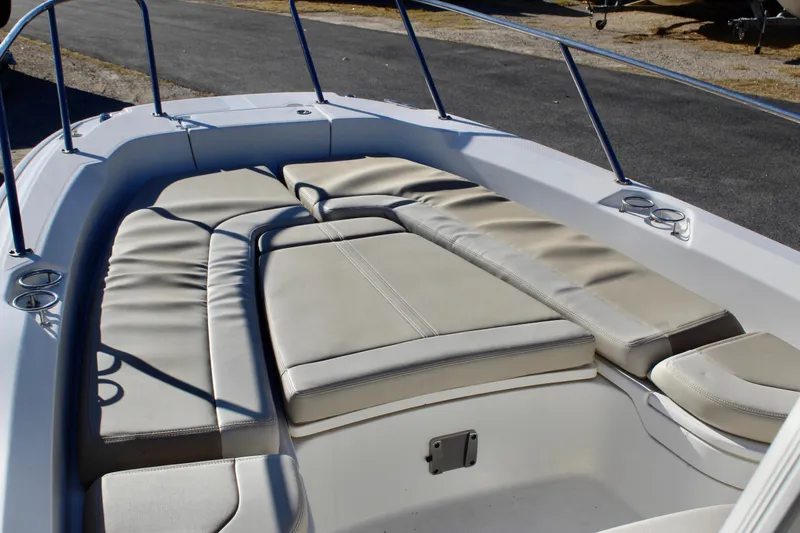 Slide: The Image of 2020 Boston Whaler 240 Dauntless boat interior with cushioned seating area. - 12