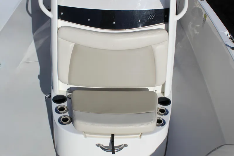Slide: The Image of 2020 Boston Whaler 240 Dauntless boat seat with cup holders and white upholstery. - 15