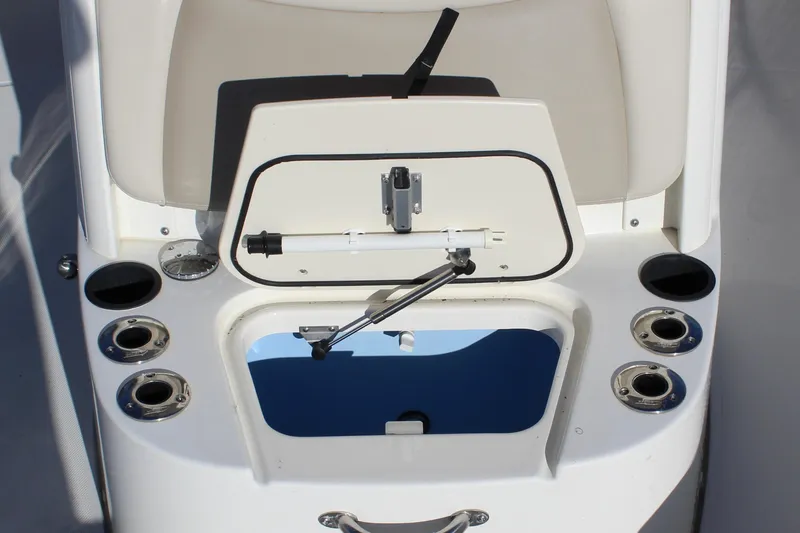 Slide: The Image of 2020 Boston Whaler 240 Dauntless boat interior with open storage compartment and cup holders. - 16