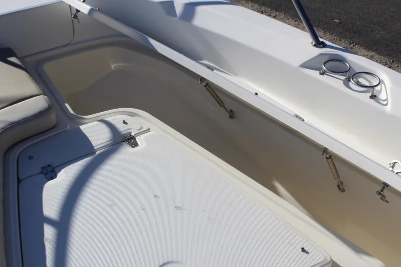 Slide: The Image of 2020 Boston Whaler 240 Dauntless boat storage compartment with cushioned seating. - 19