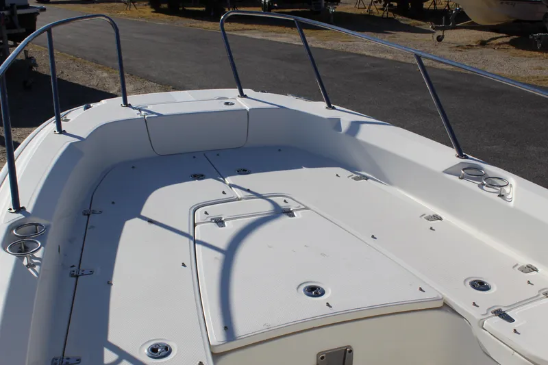 Slide: The Image of 2020 Boston Whaler 240 Dauntless boat deck with railings and storage compartments. - 20