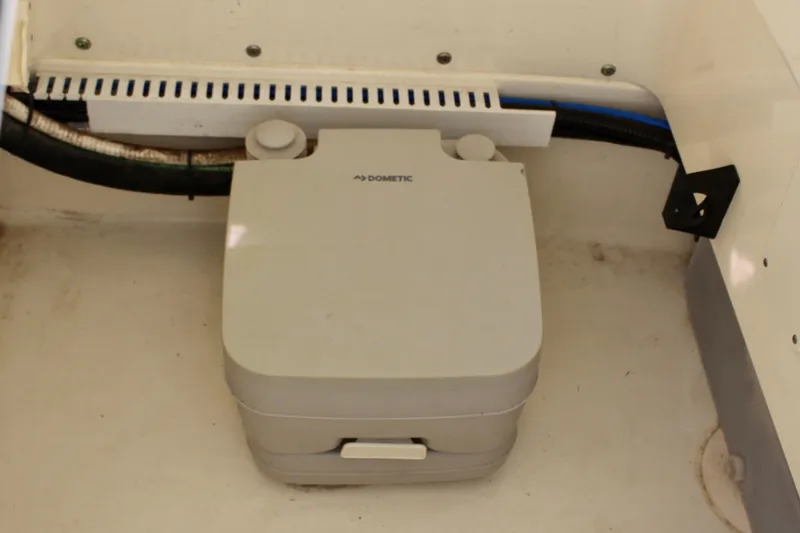 Slide: The Image of Portable toilet in 2020 Boston Whaler 240 Dauntless boat interior. - 21